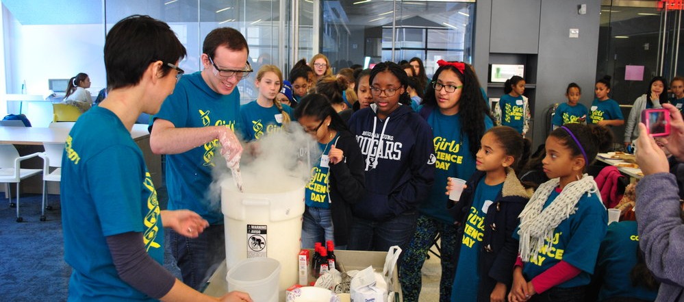Students watching volunteers make liquid nitrogen ice cream at girl's science day